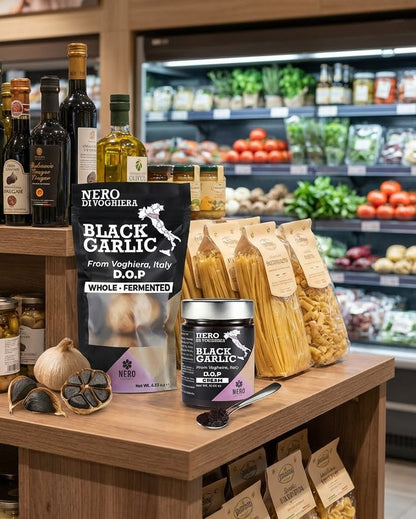 Nero di Toscana black garlic products on a wooden shelf with grocery store background