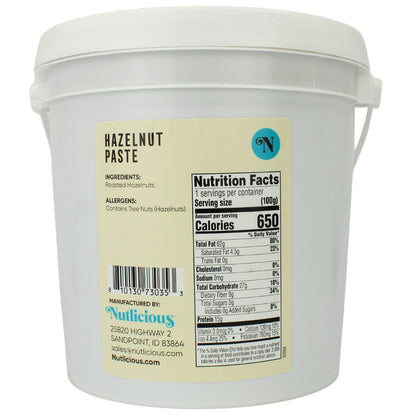 White container of hazelnut paste with a label showing nutrition facts and ingredients.