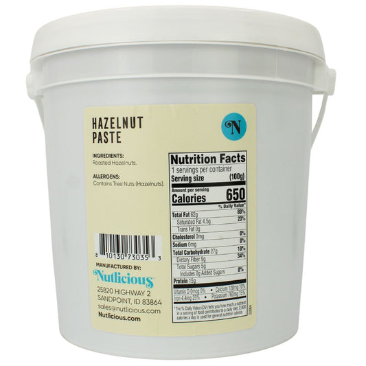 White container of hazelnut paste with a label showing nutrition facts and ingredients.