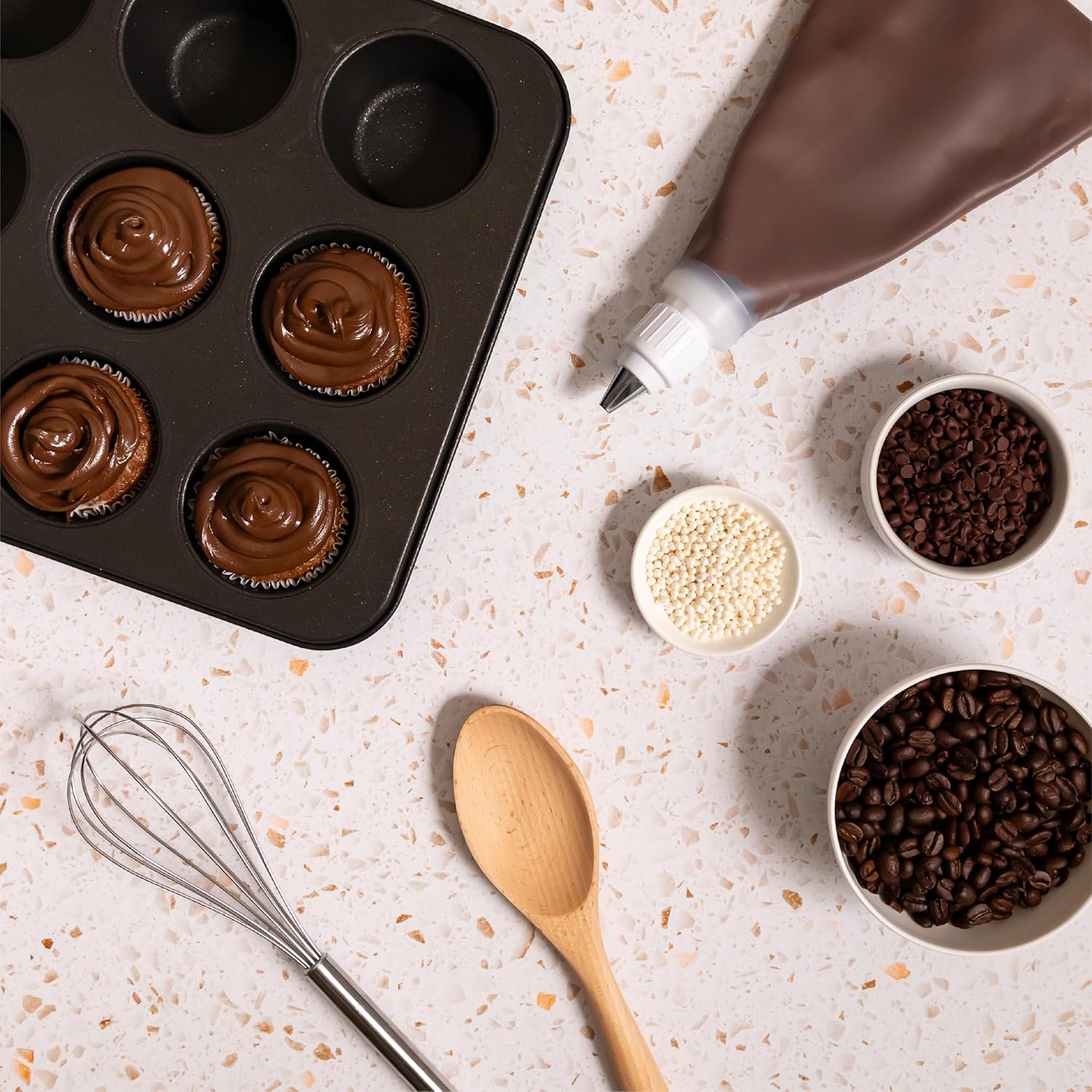 muffin-pan-with-chocolate-hazelnut-espresso-frosting-piping-bag-coffee-beans-and-baking-tools