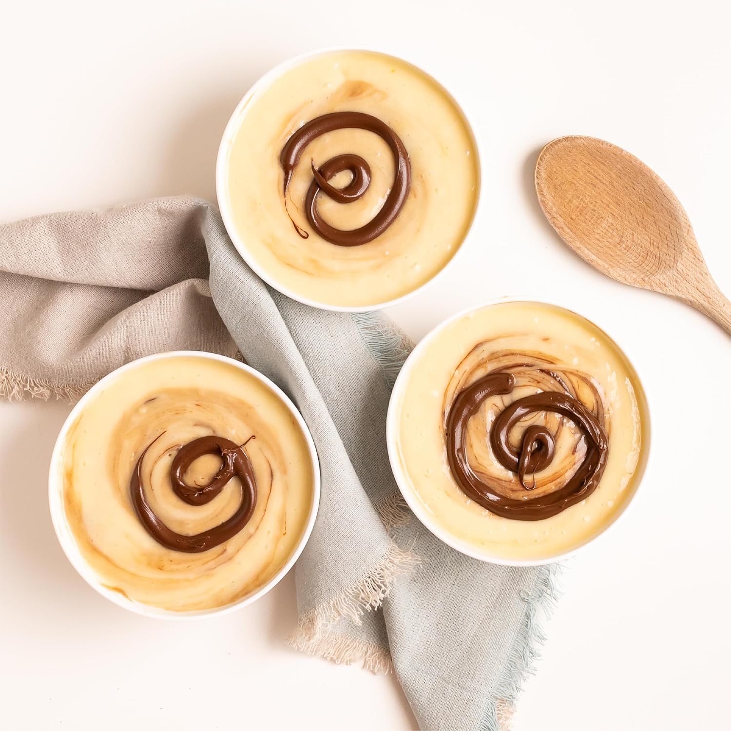 Bowl of creamy dessert swirled with Nutlicious Hazelnut Mocha Spread.