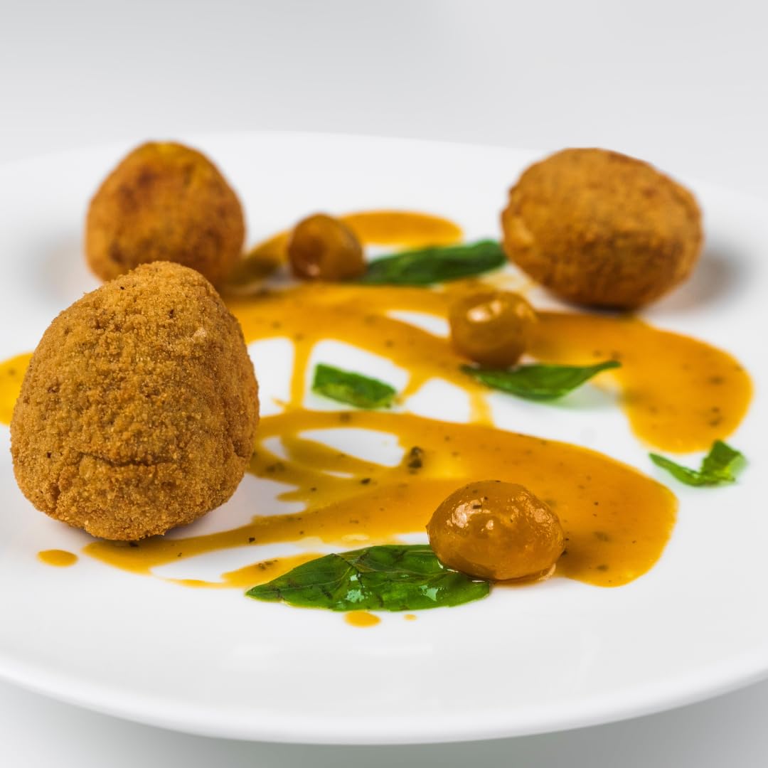 Crispy fried balls with a drizzle of orange sauce on a white plate