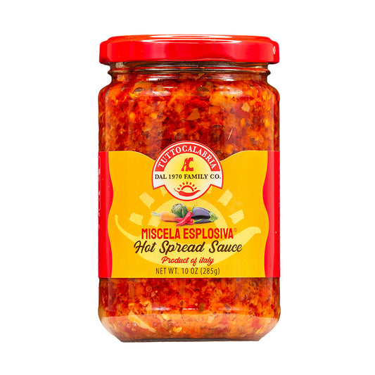 Jar of hot spread sauce with a red lid on a white background