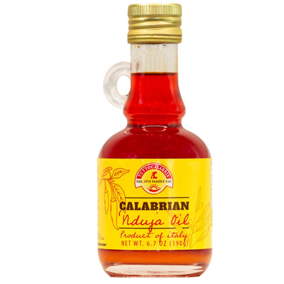 Bottle of Calabrian Nduja Oil with a yellow label on a white background