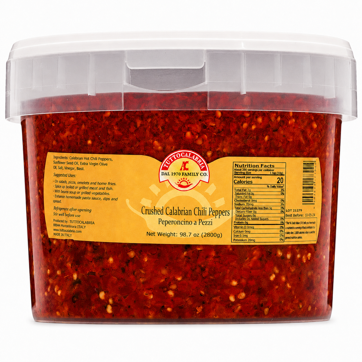 A clear plastic tub filled with crushed red chili peppers, featuring a yellow label with the Instituto Latino brand logo and product details, set against a plain white background.