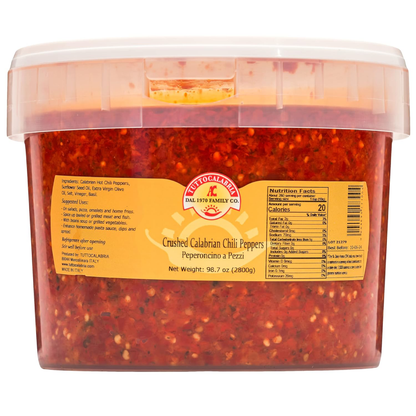 Container of crushed Calabrian chili peppers with a label on a white background