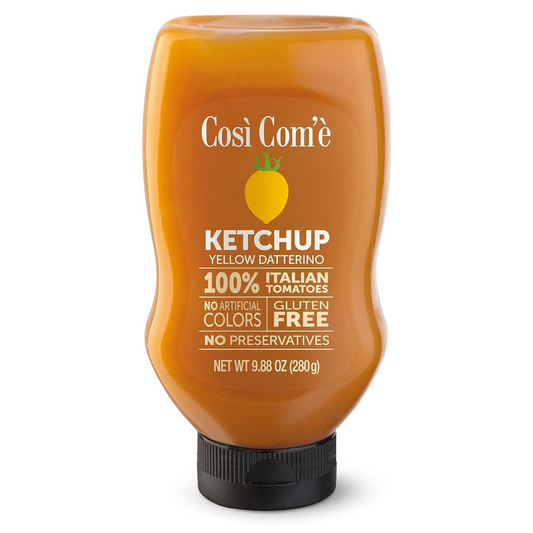 A bottle of Cosé Com'è Italian Yellow Tomato Ketchup with label detailing product name, weight (9.88 oz), and attributes such as no artificial colors, preservatives, and gluten-free.