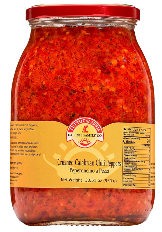 Jar of crushed Calabrian chili peppers with a red lid and yellow label.