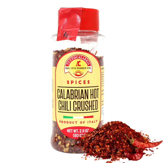 Jar of Calabrian hot chili crushed spices with a red cap on a white background