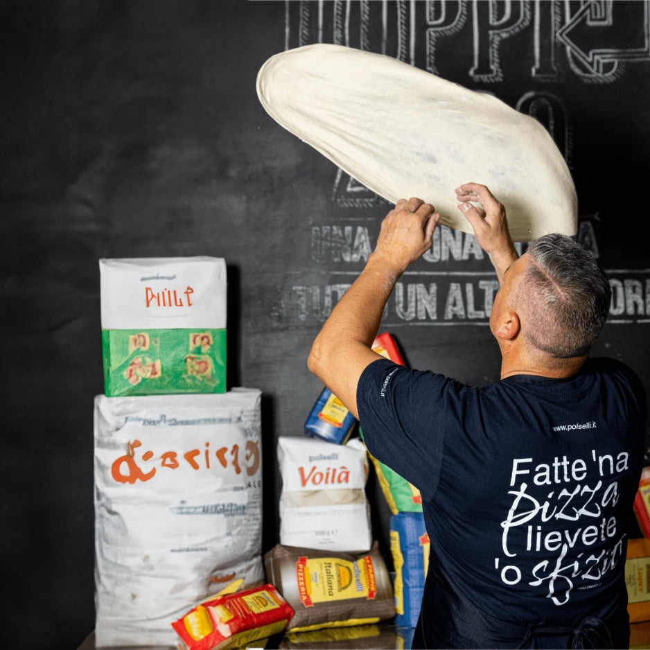 Professional pizzaiolo stretching dough using Polselli flour
