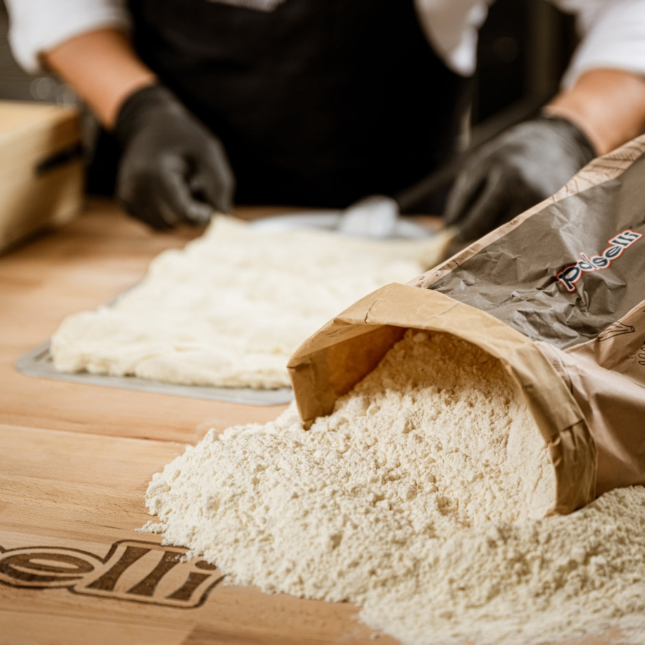Polselli stone-milled Italian flour being poured during dough preparation