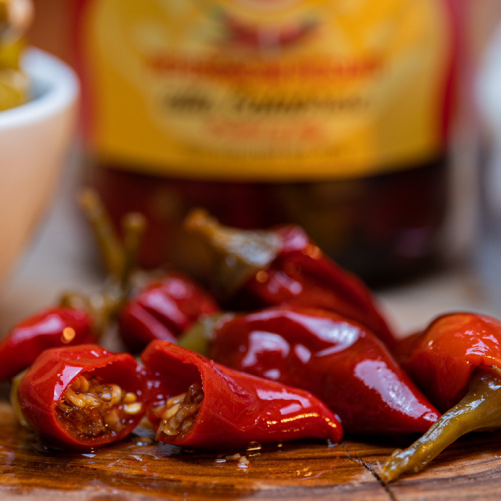 Fresh Calabrian chili peppers from Tutto Calabria, sliced and ready for cooking, highlighting their vibrant color and premium quality used by chefs