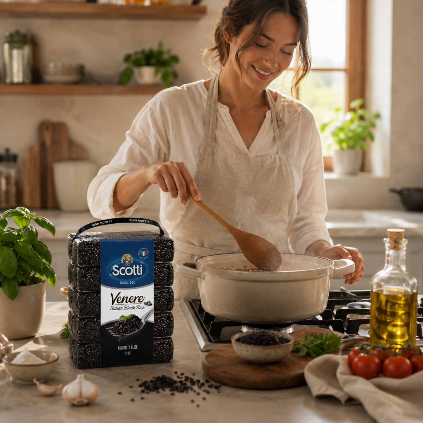 A woman in a white shirt and apron stirs a pot on a stove in a warm kitchen setting, with a bag of Scotti Veneře Italian Sweet Bean Soup mix placed in the foreground among cooking ingredients and plants.