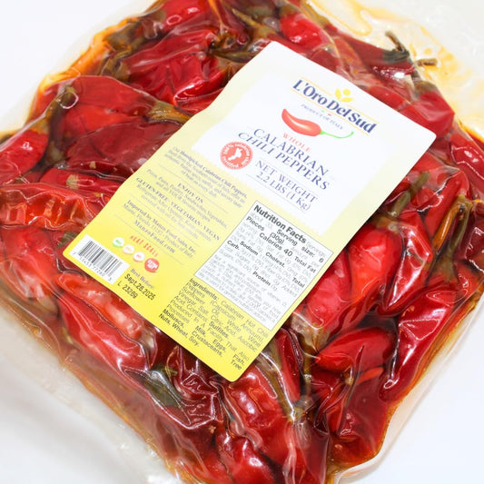 Packaged red peppers with a label on a white background